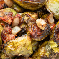 a close up photo of roasted brussels sprouts with bacon