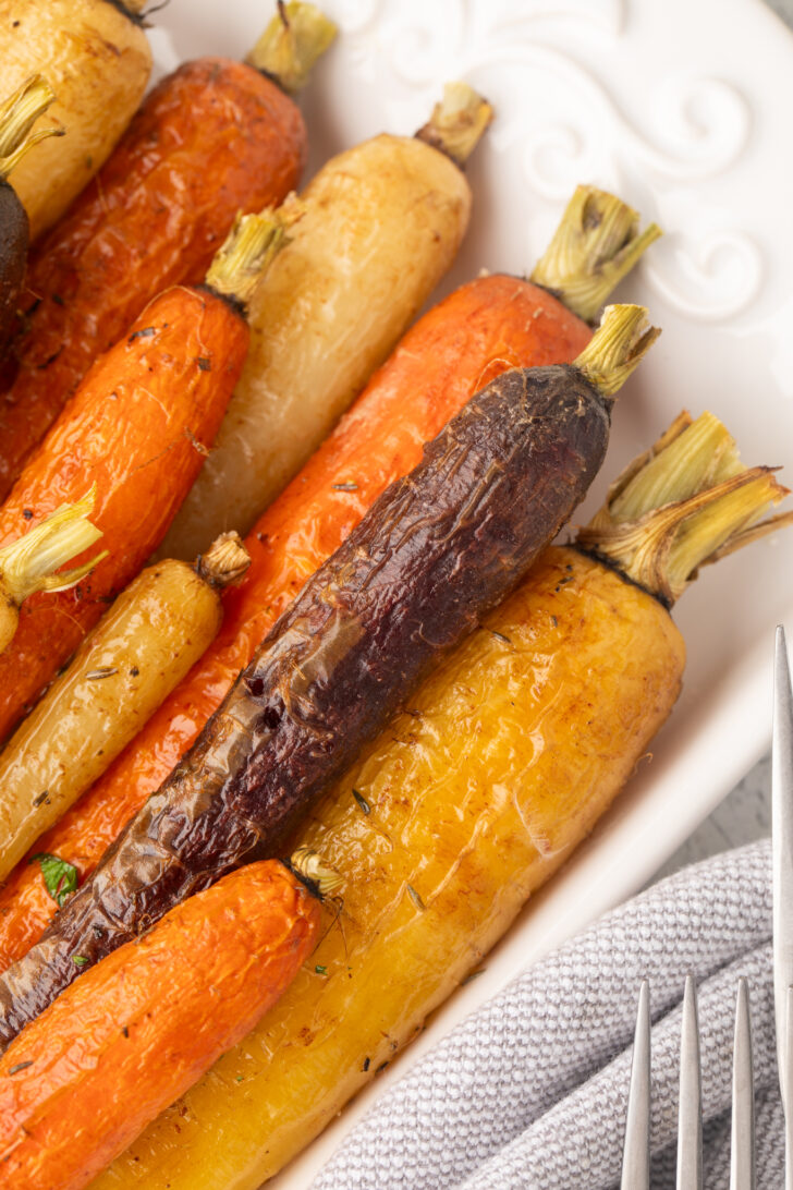 a close up photo of roasted rainbow carrots