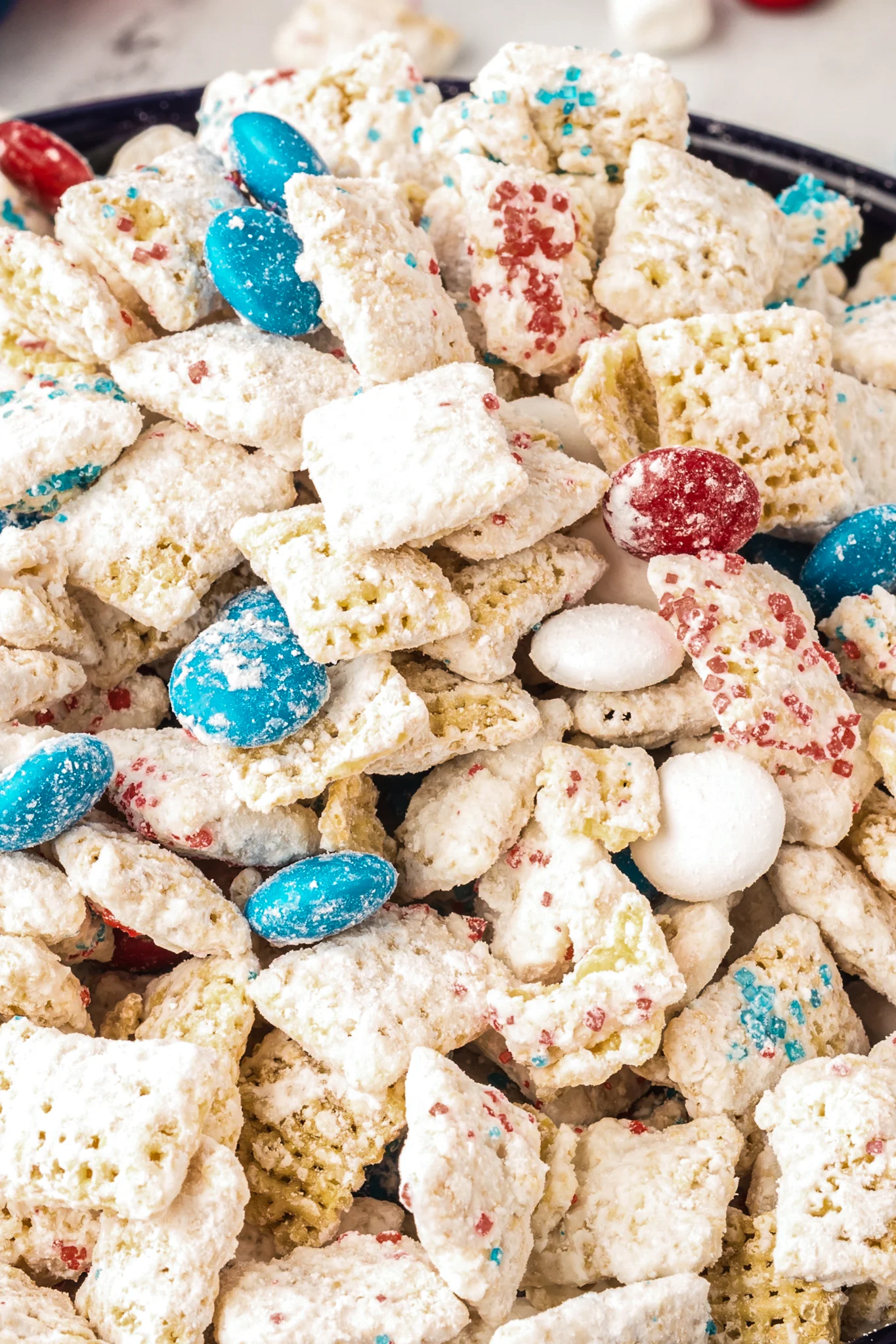 A close up shot of white chocolate puppy chow with M&M's