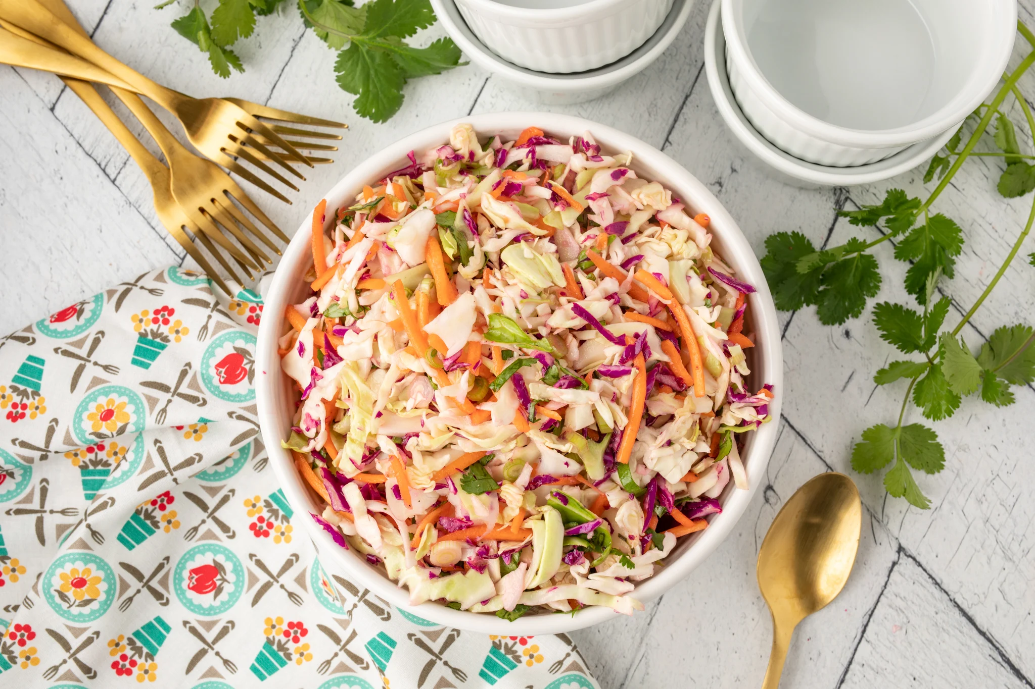 an overhead photo of cilantro lime cole slaw in a bowl 