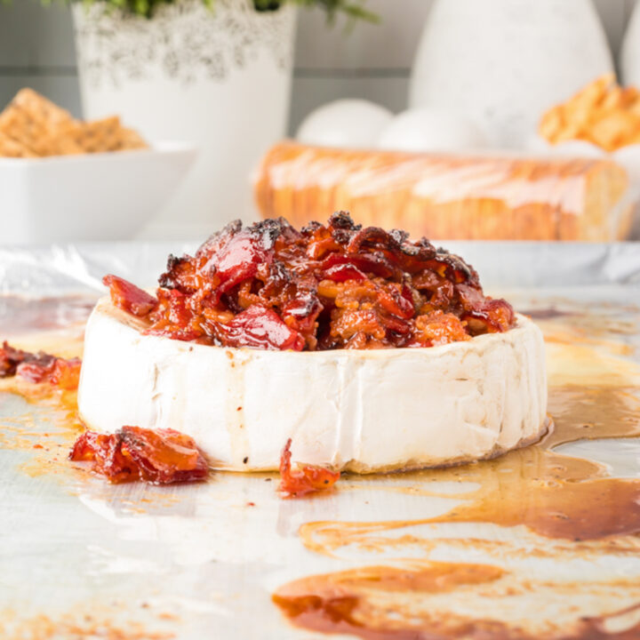 A photo of baked brie topped with candied bacon