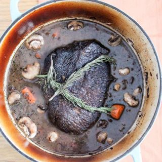 Fork tender beef pot roast with red wine, mushrooms, and root vegetables. Braised in the oven, but there's an option for the crock pot or slow cooker!