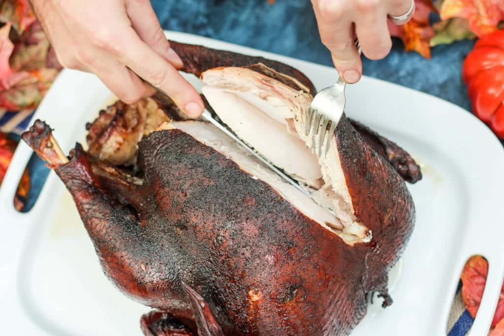 a smoked turkey being sliced into