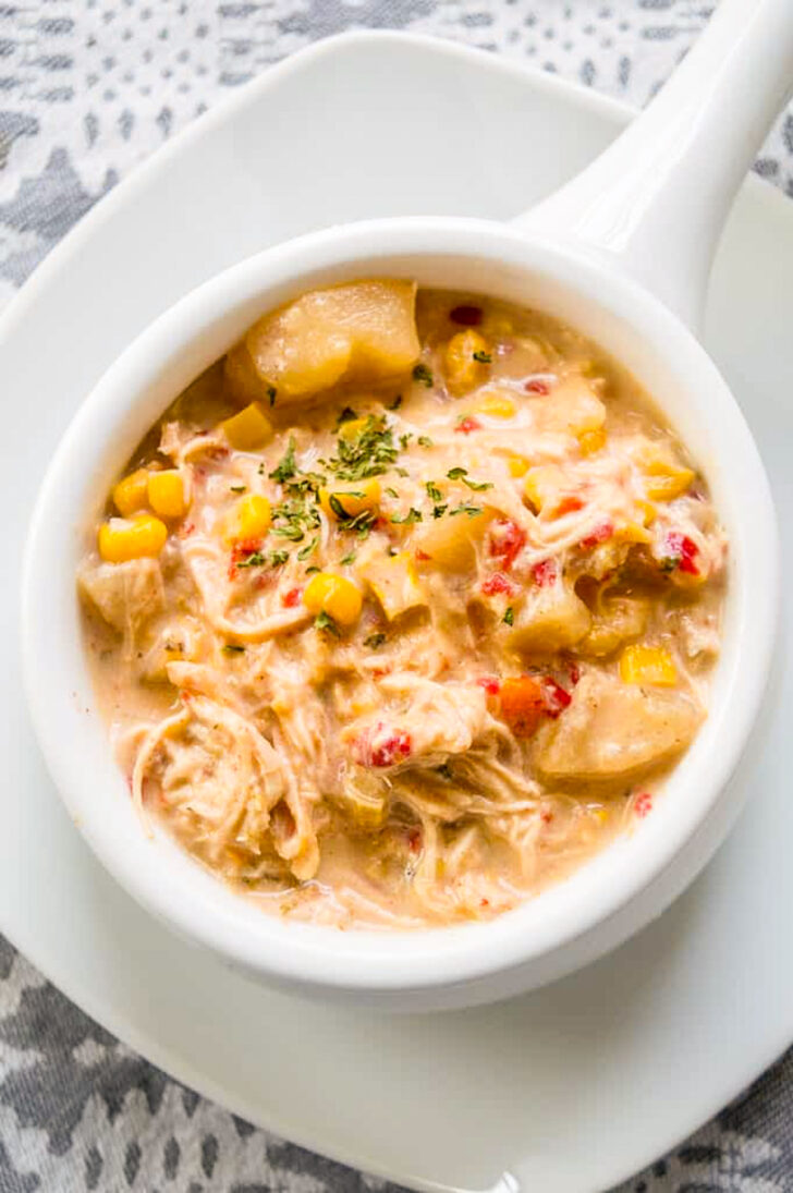a photo of a white bowl filled with slow cooker chicken chowder