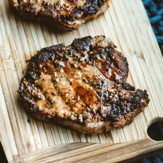 a photo of a grilled pork chop on a cutting board