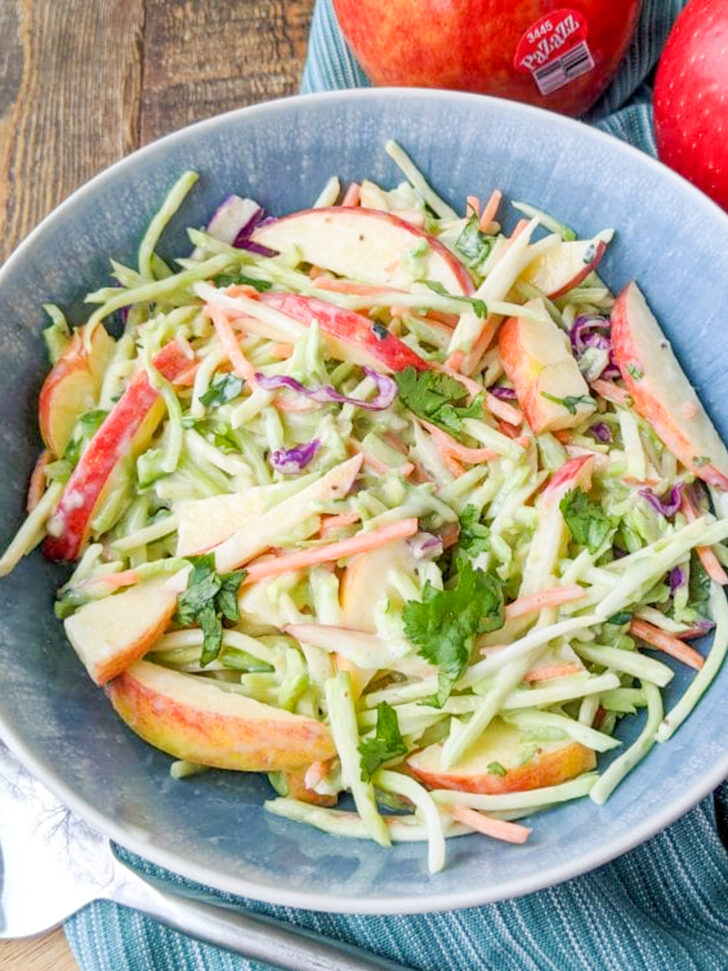 a photo of a bowl of broccoli slaw and apples in a bowl