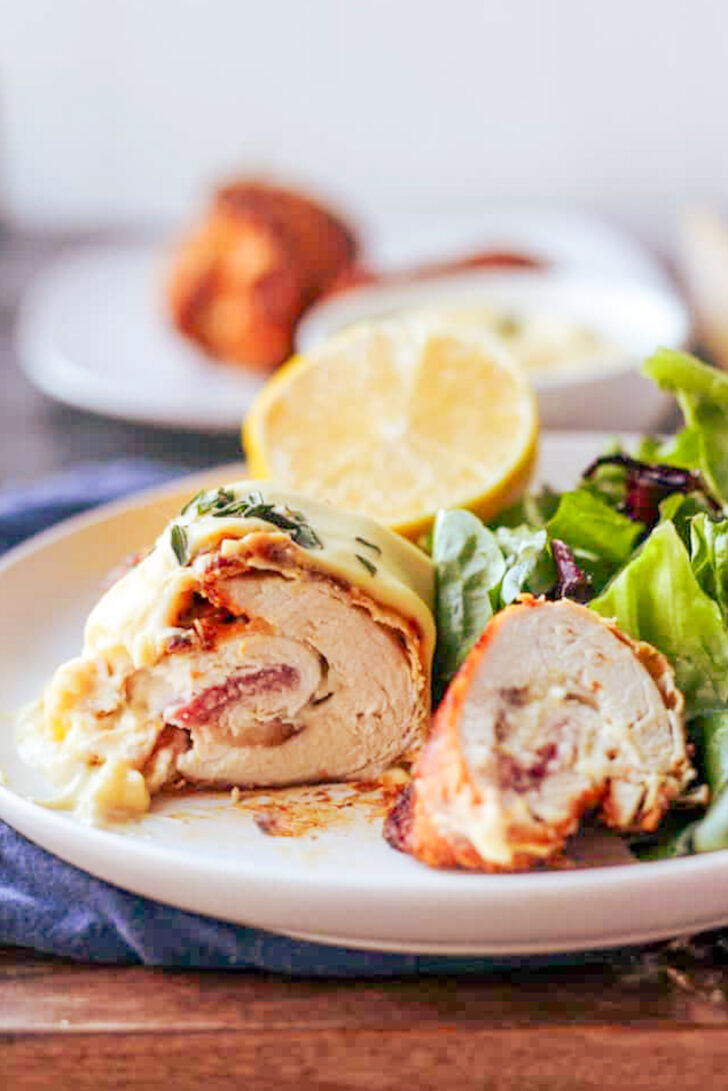 a photo of a piece of air fryer chicken cordon bleu cut into two pieces