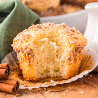 A photo of a cinnamon muffin with a bite out of it