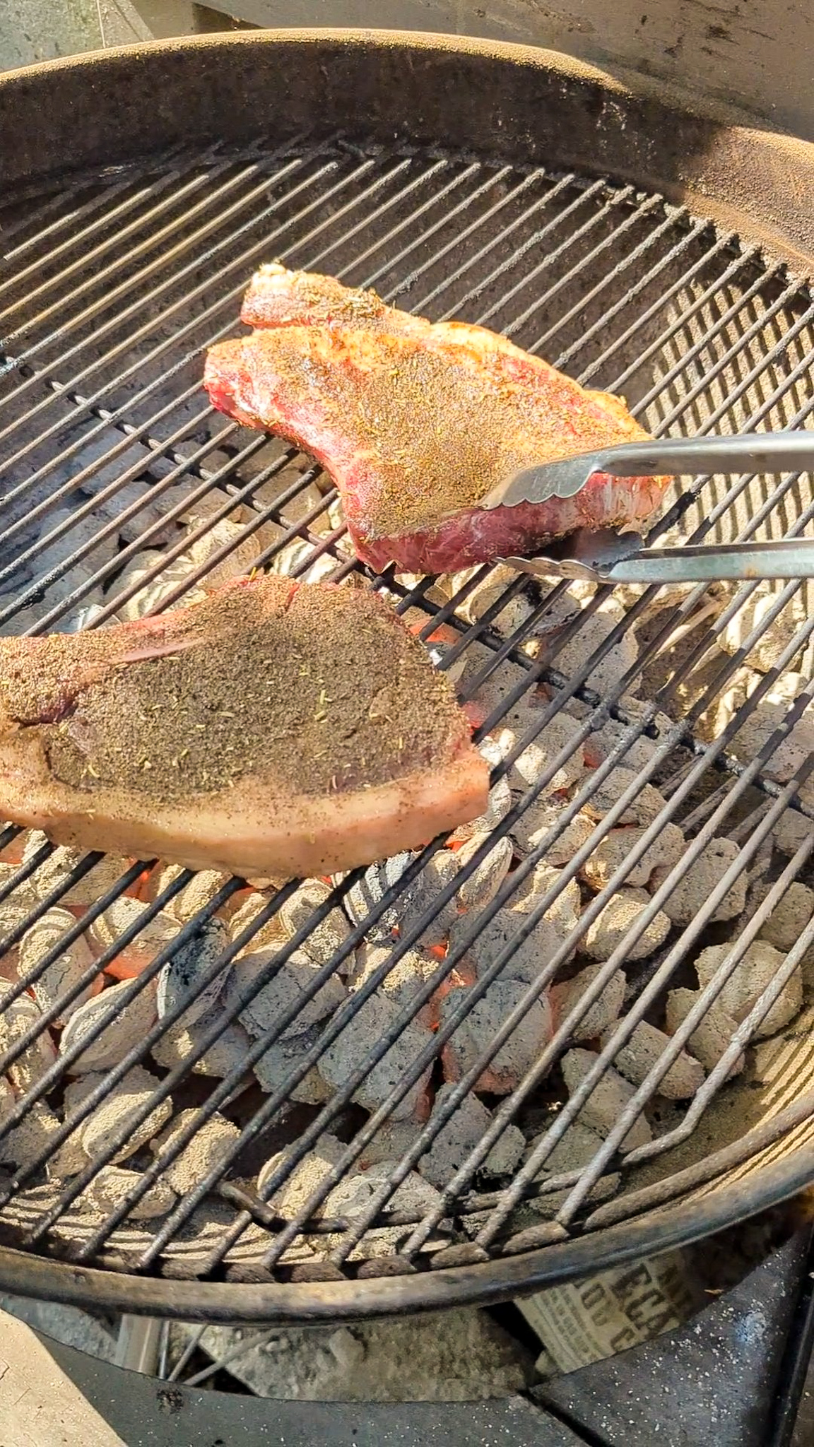 a photo of ribeyes on the grill