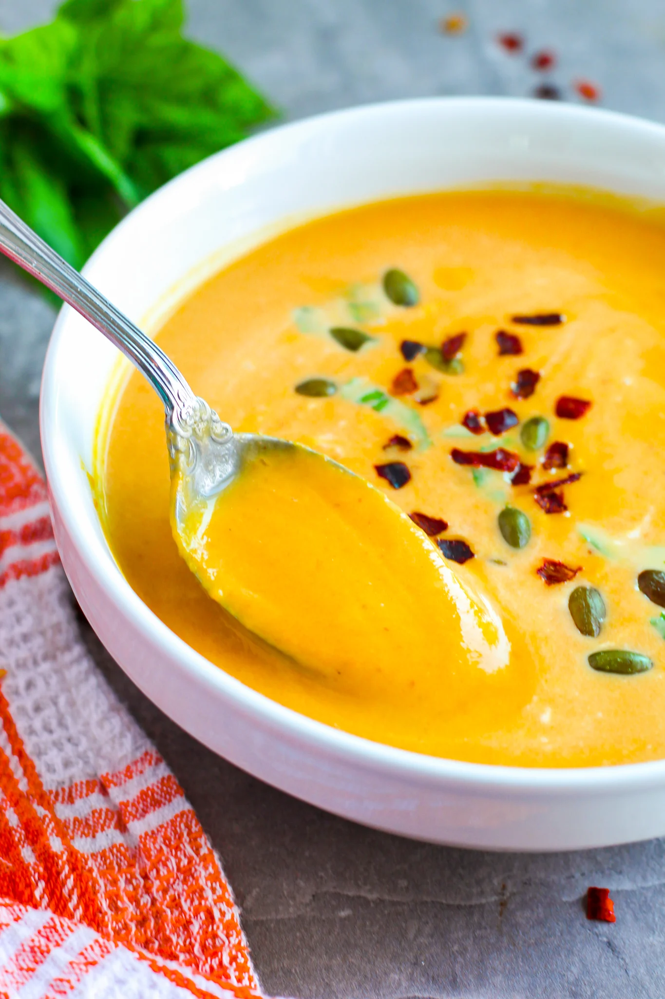 A photo of a spoonful of pumpkin soup