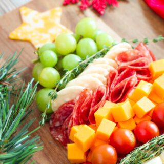 a photo of christmas charcuterie on a wooden board