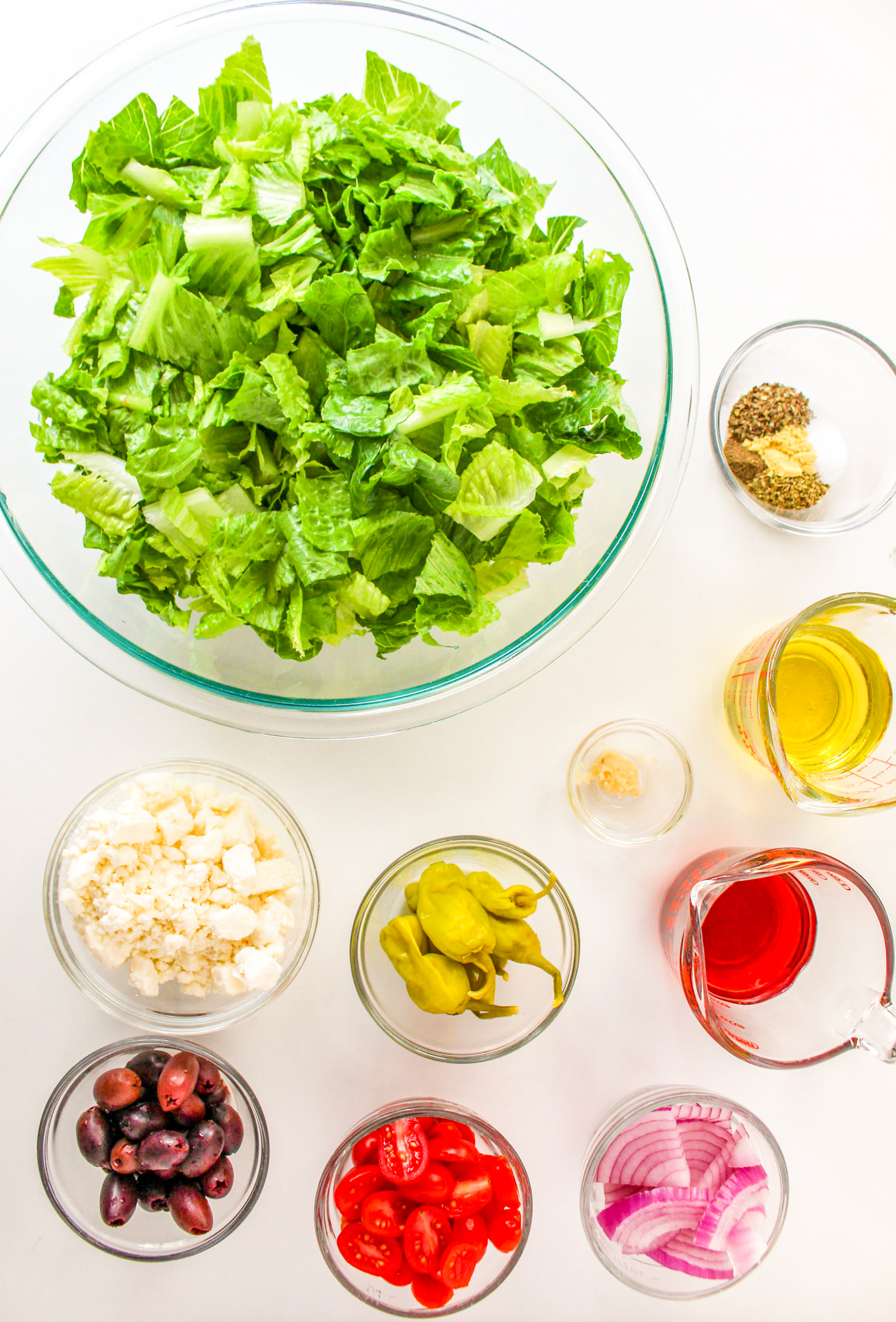 a photo of Greek salad ingredients in separate bowls