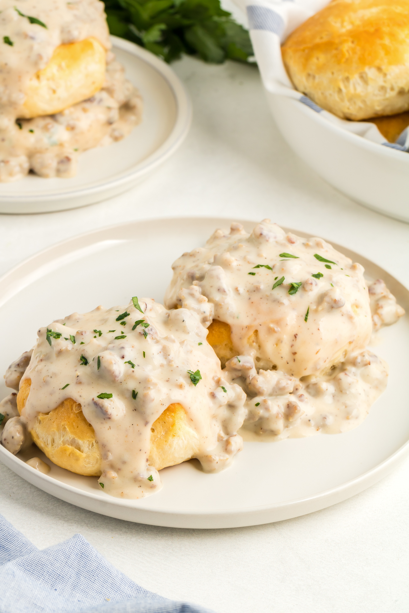 a photo of biscuits and gravy on a white plate