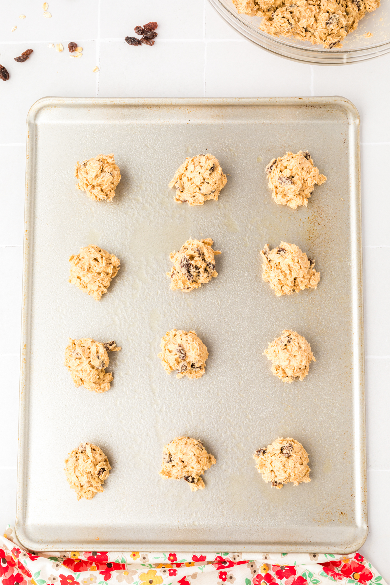 a photo of gluten free oatmeal cookie dough balls on a baking sheet