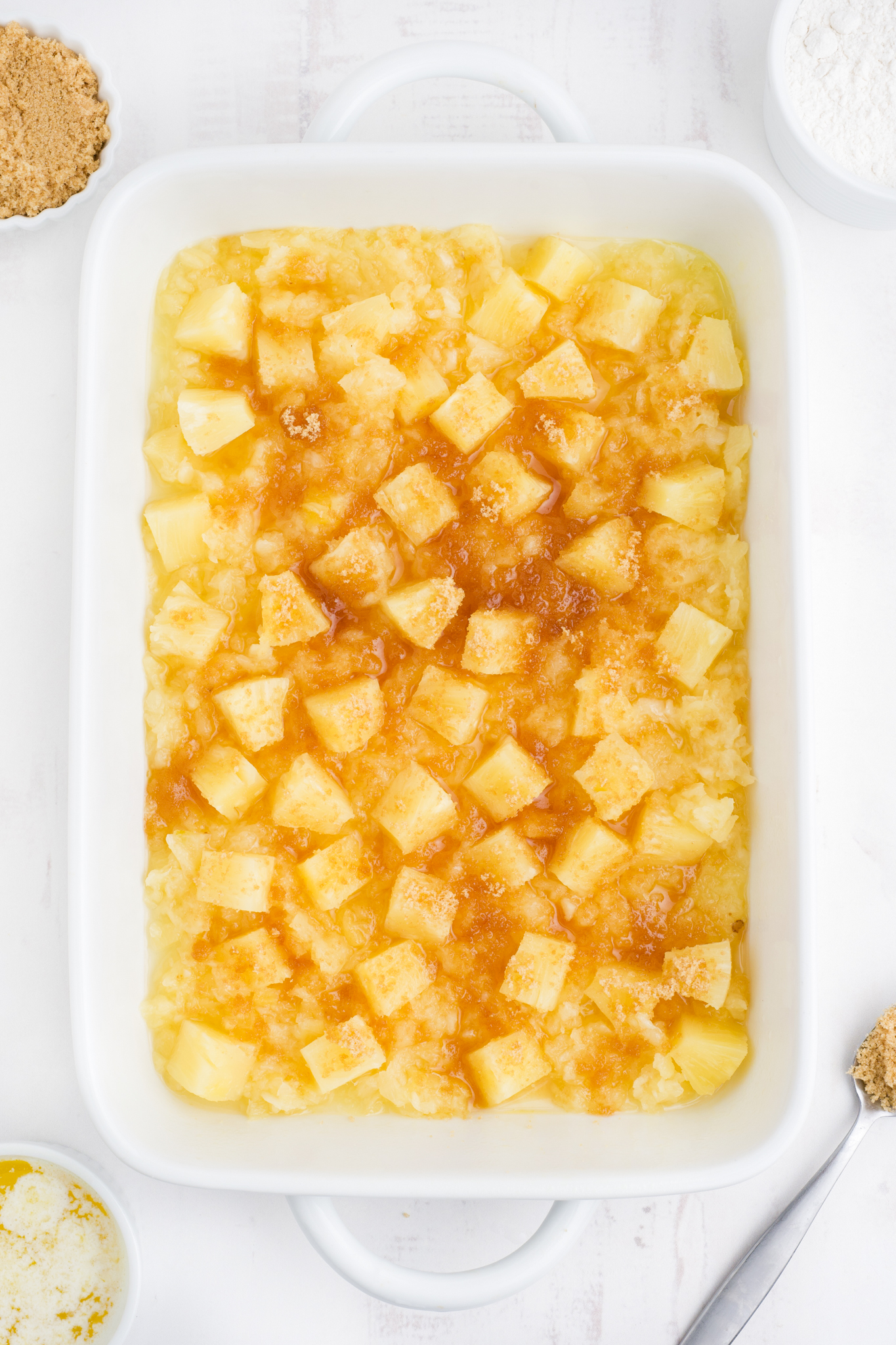 A photo of the bottom layer of pineapple dump cake - canned pineapple, brown sugar and cinnamon