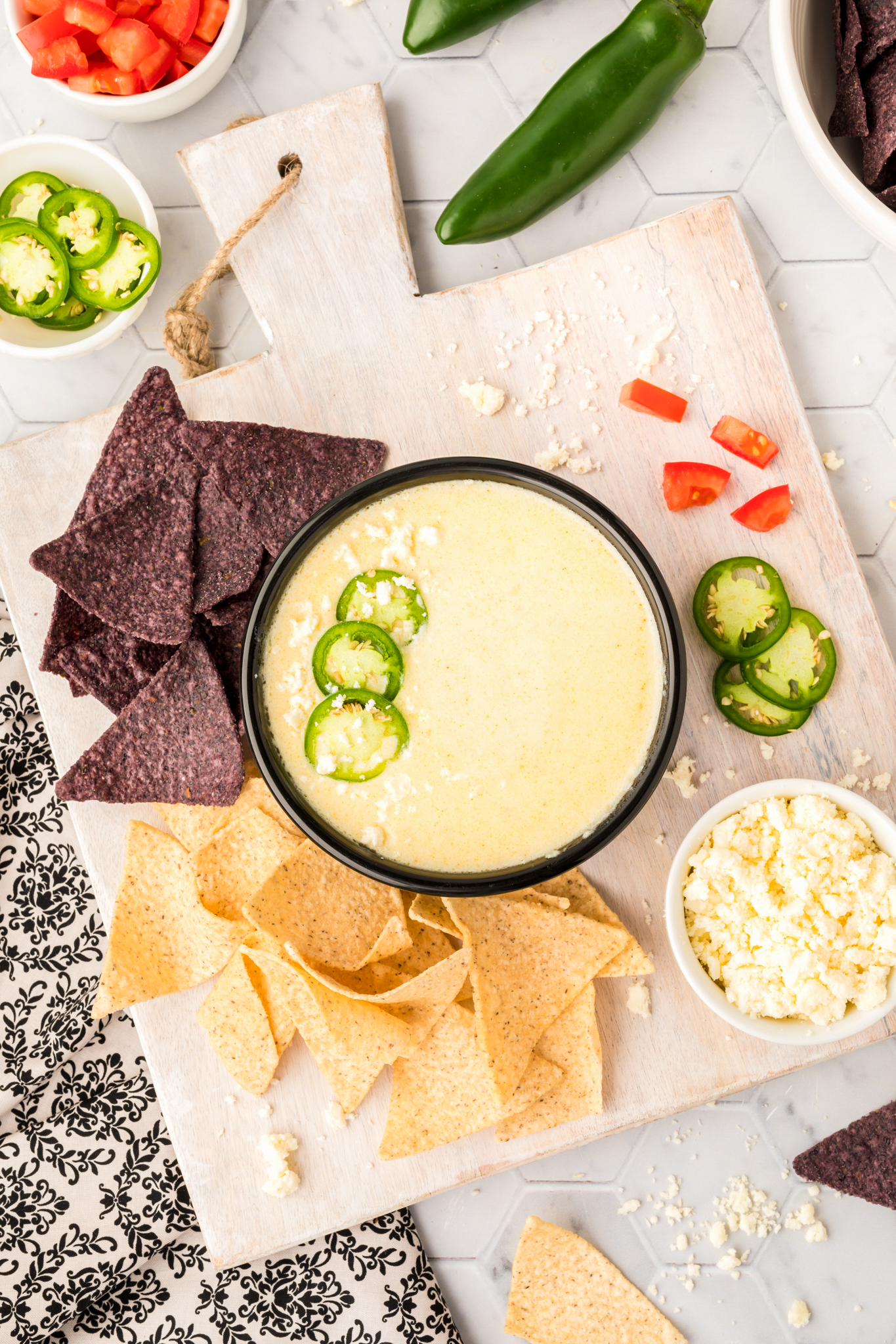 An overhead photo of white queso dip with tortilla chips