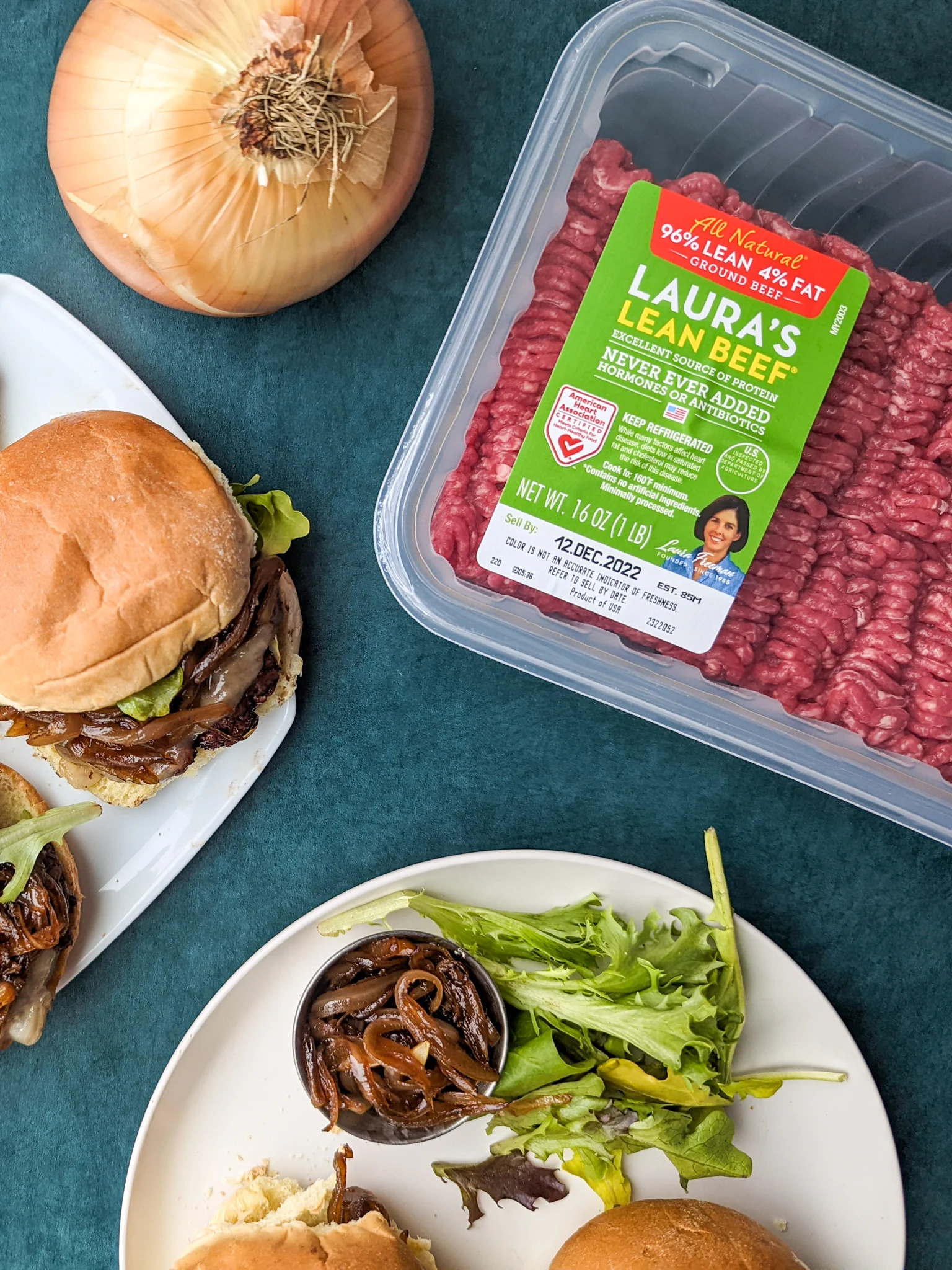 An overhead photo of cooked slider burgers and a package of Laura's Lean ground beef