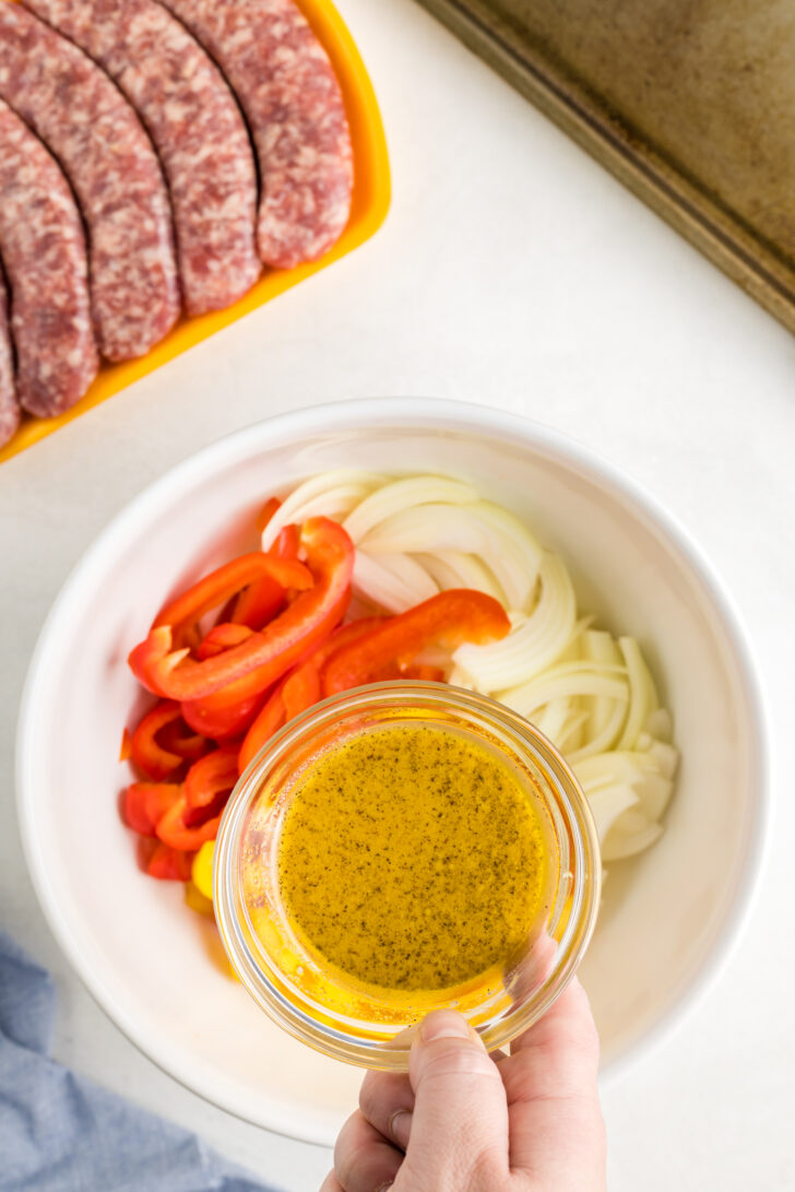 a photo of a bowl of veggie and mustard dressing for bratwursts