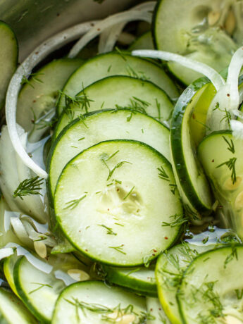 a close up photo of cucumber and onion salad