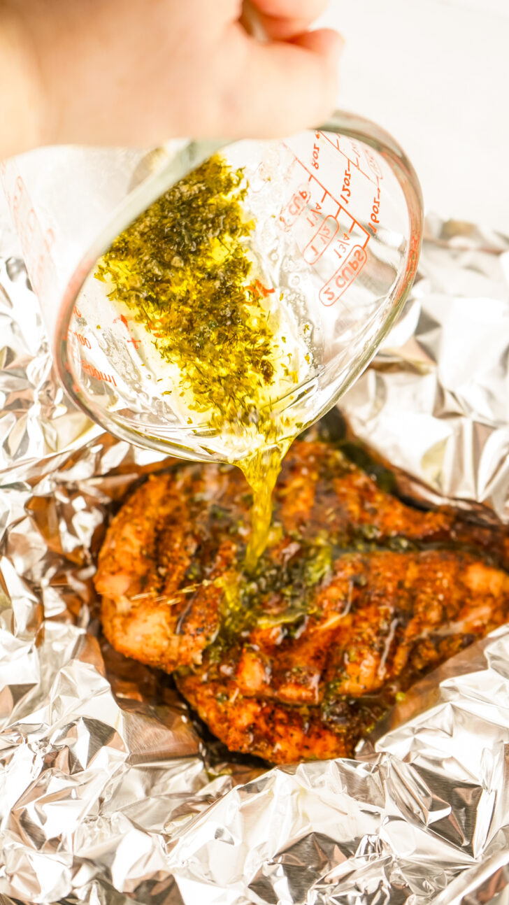 a photo of herb garlic butter being poured over the top of a smoked turkey breast