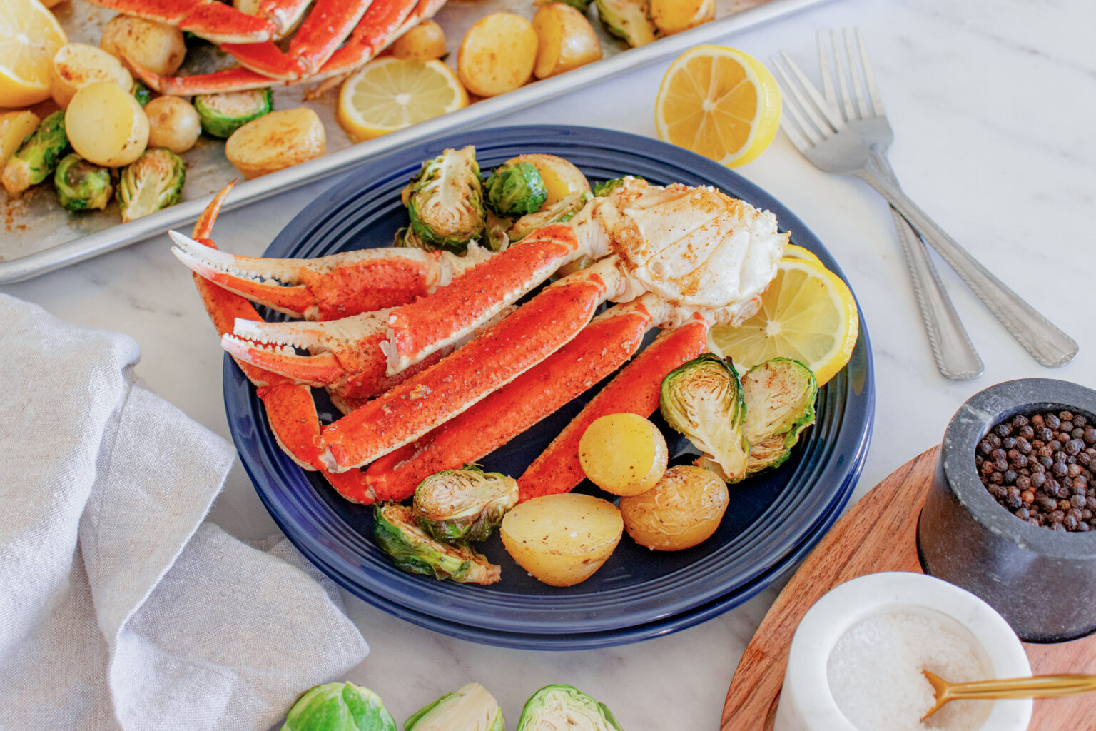Garlic Butter Crab Legs with Roasted Brussels Sprouts + Potatoes