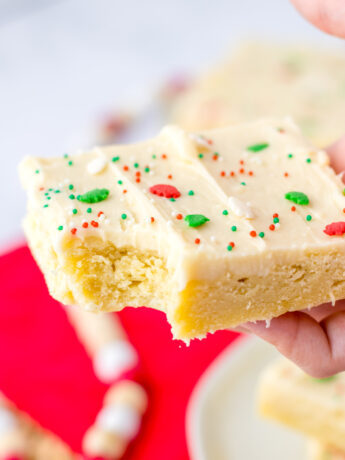 a photo of a Christmas sugar cookie bar with a bite taken out of it