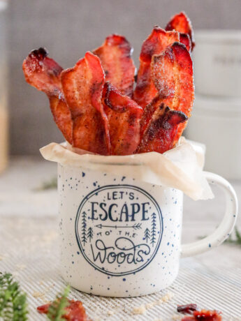 a photo of cooked air fryer candied bacon in a coffee mug