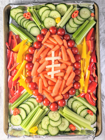 a photo of a veggie tray shaped like a football