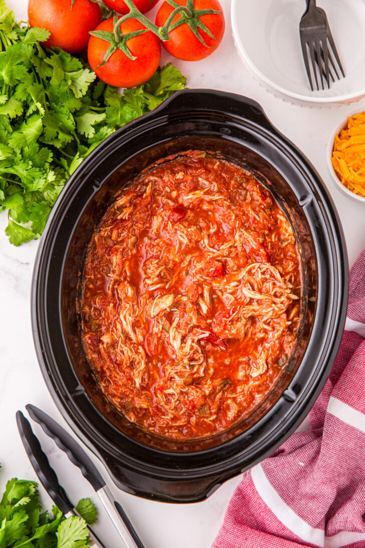 a photo of a crockpot full of salsa chicken