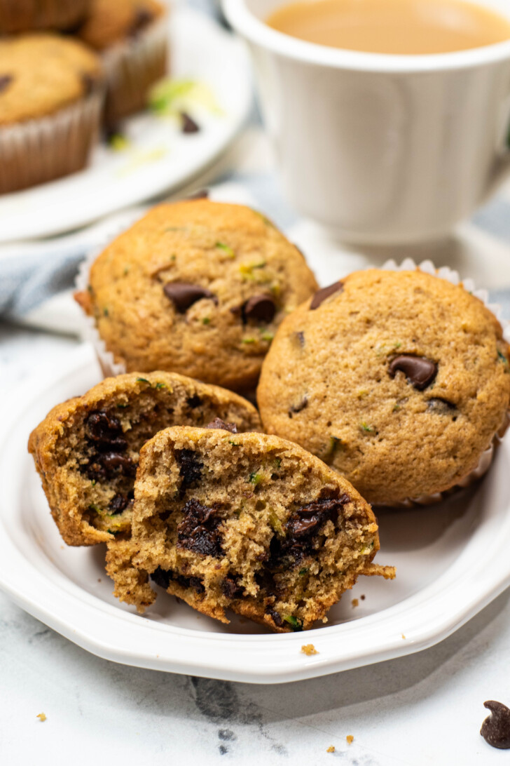 a white plate filled with chocolate chip zucchini muffins