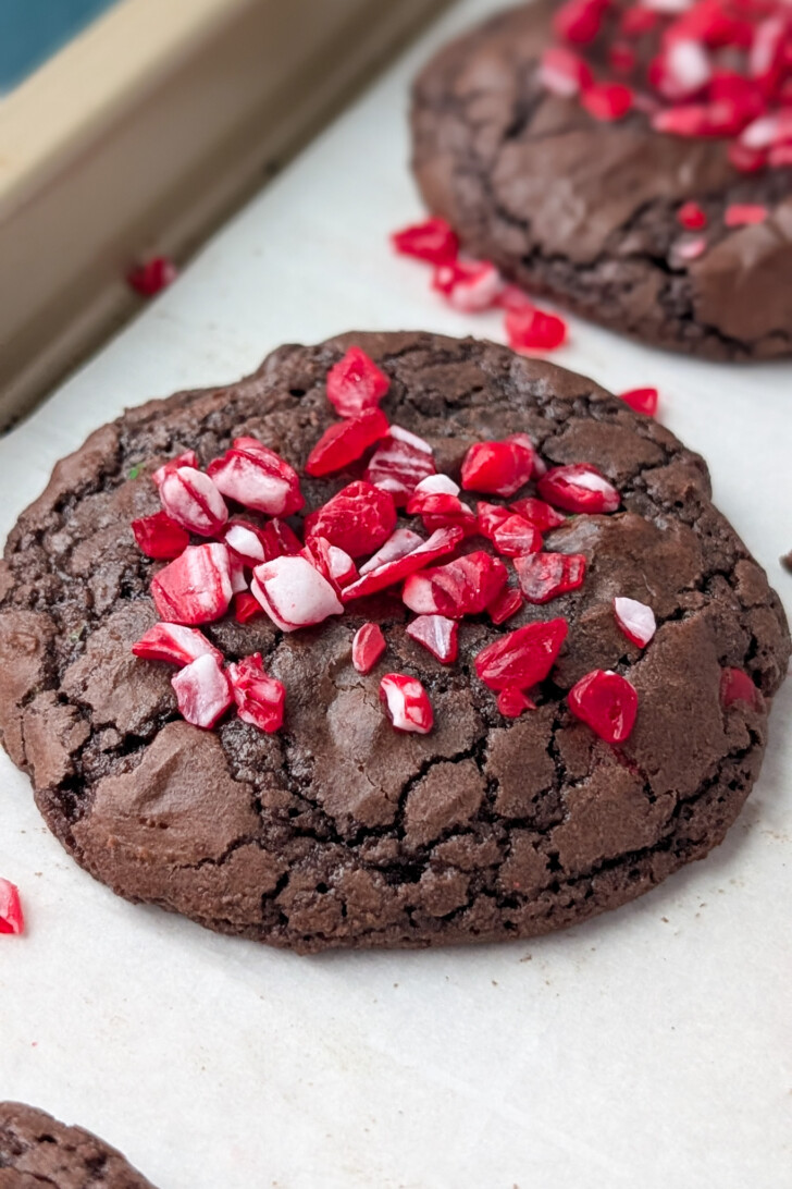 a photo of a chocolate cookie with crushed peppermint on top