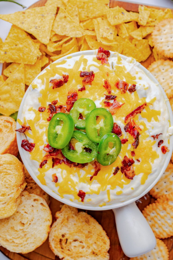 an overhead view of a dip in a bowl surrounded by crackers