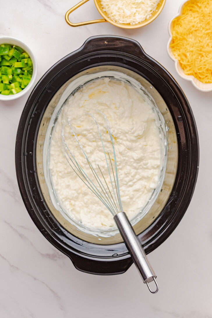 cream cheese and sour cream in a crockpot