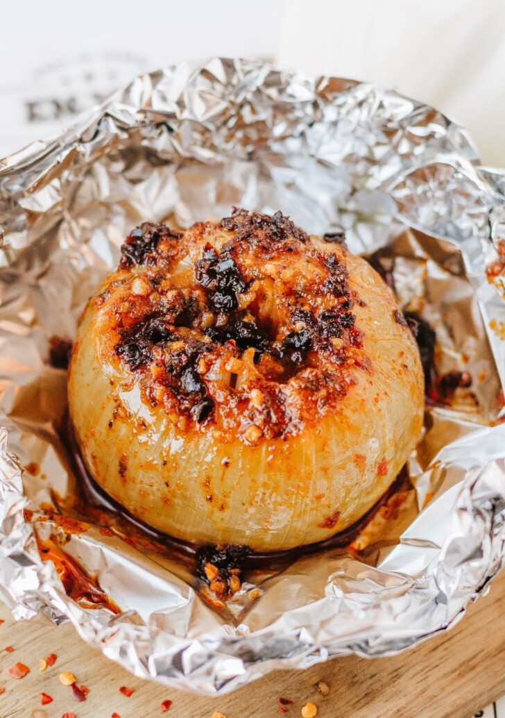 a baked onion in aluminum foil