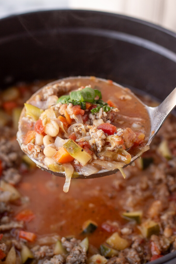 A ladle full of italian sausage soup
