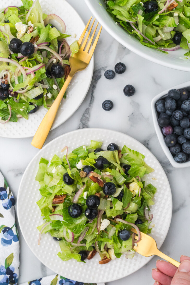 a white plate with a salad on it