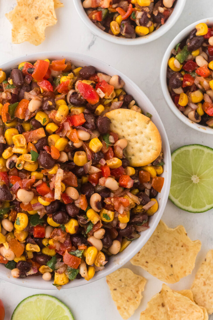 A cracker being dipped in cowboy caviar