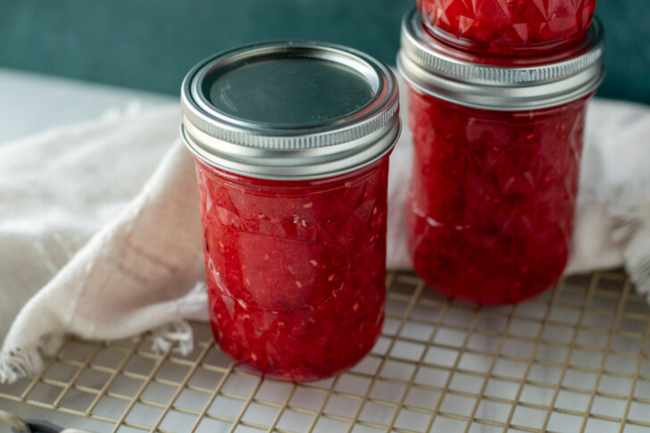two glass jars filled with raspberry jam