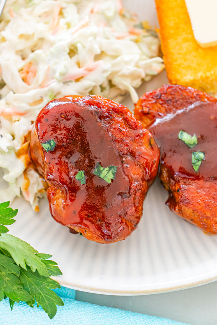 a pork medallion on a plate with rice