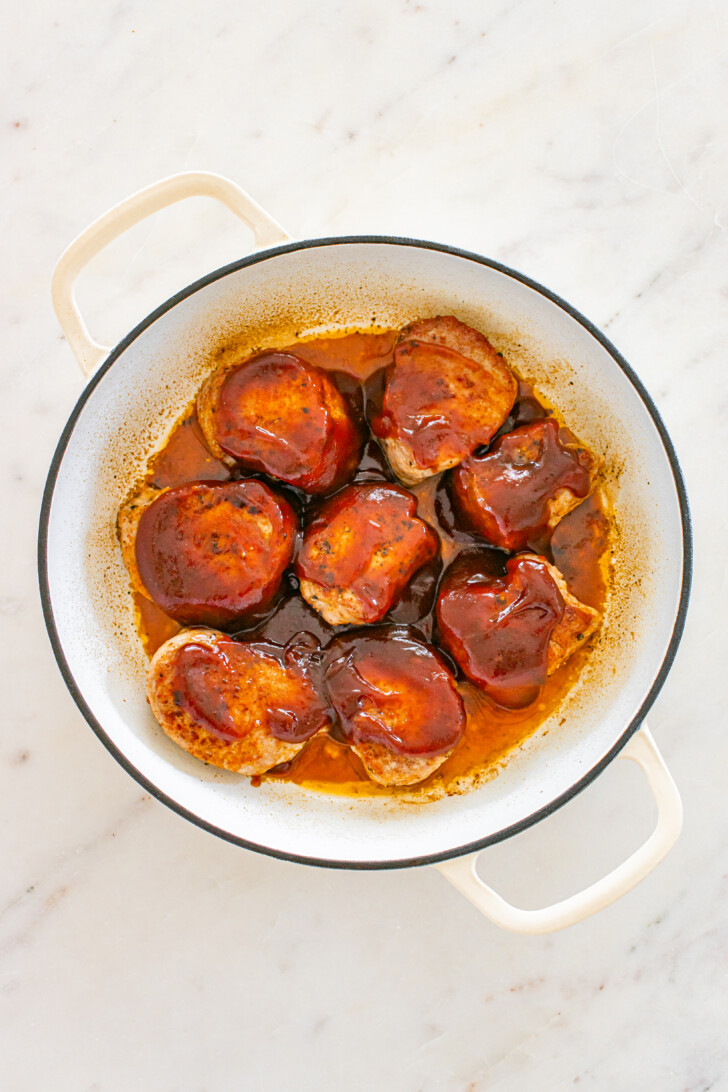 pork medallions in barbecue sauce in a Dutch oven