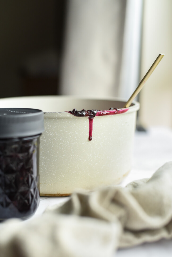 blueberry jam dripping down the side of a pot