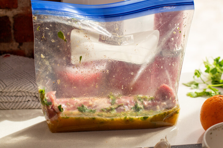 pork tenderloin being marinaded in a ziploc bag