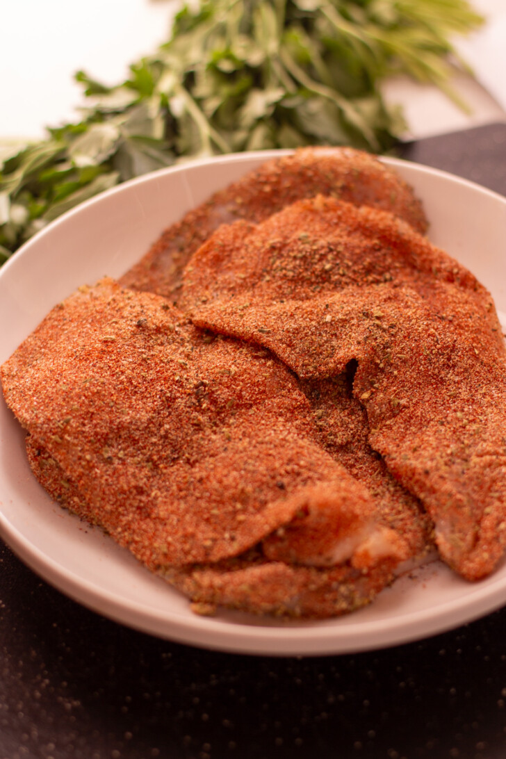 raw chicken breasts coated in blackened seasoning