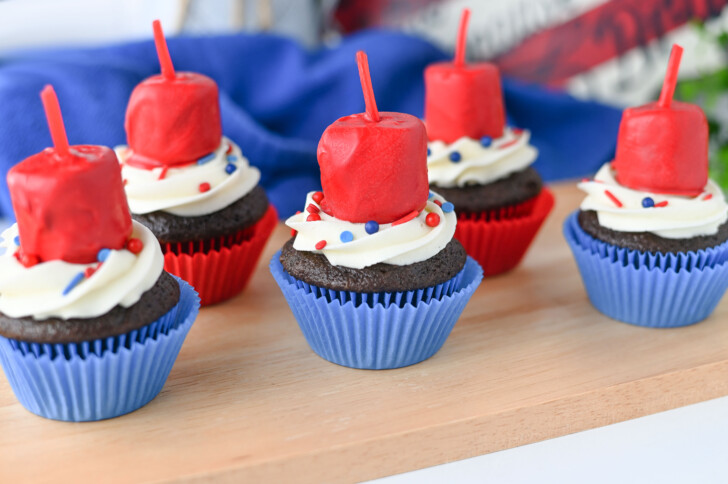 patriotic cupcakes on a wooden tray