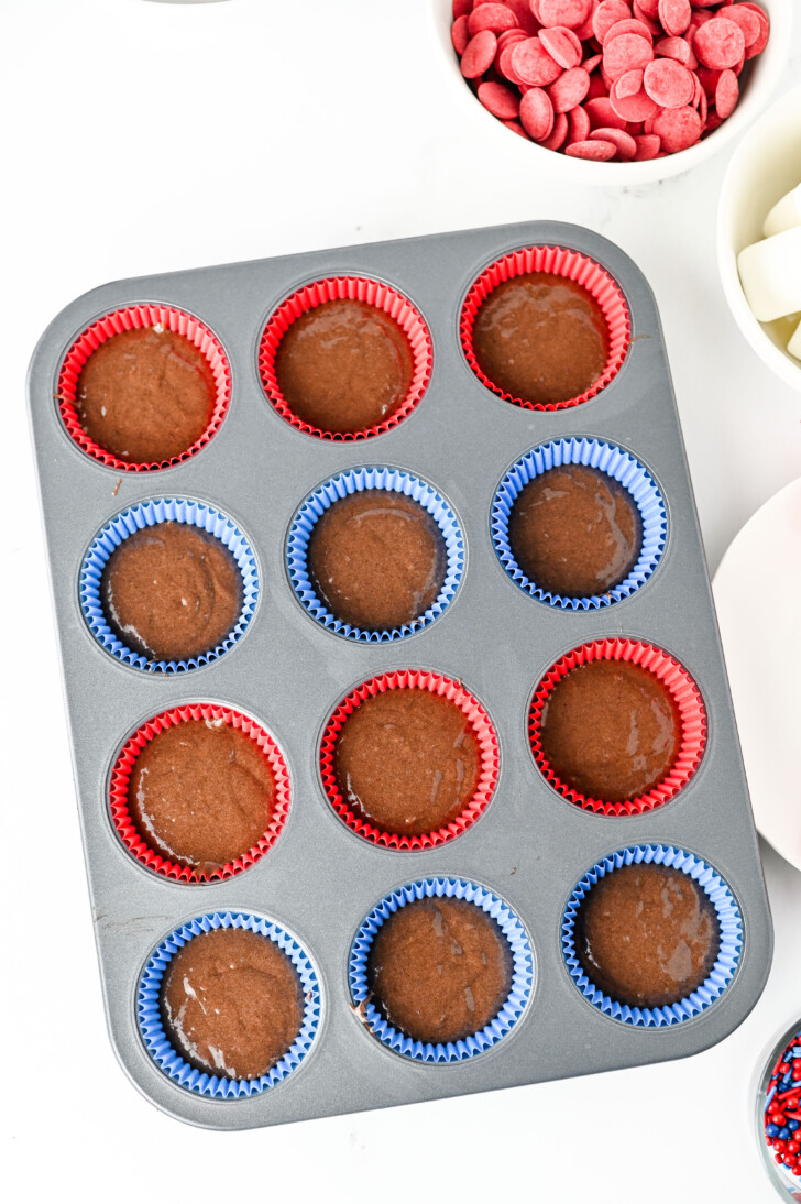 chocolate cupcake batter in a cupcake tin