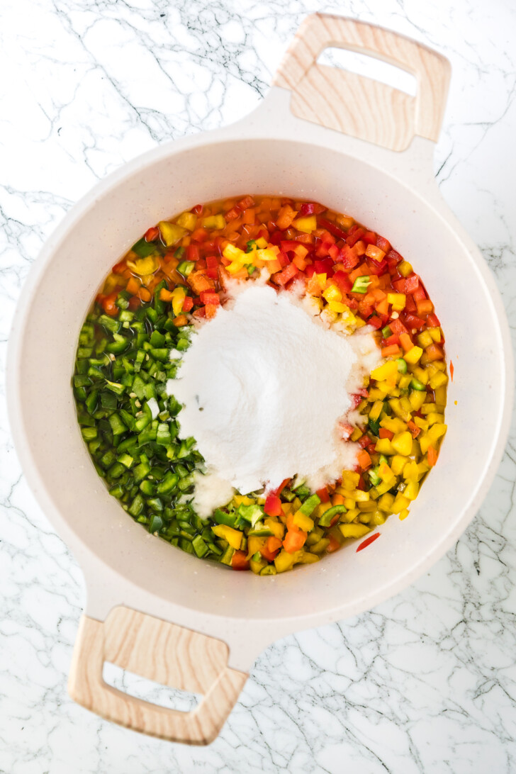 chopped peppers in a pot with sugar
