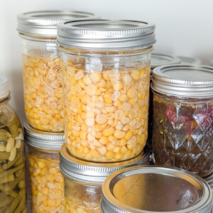 jars of canned corn on a shelf