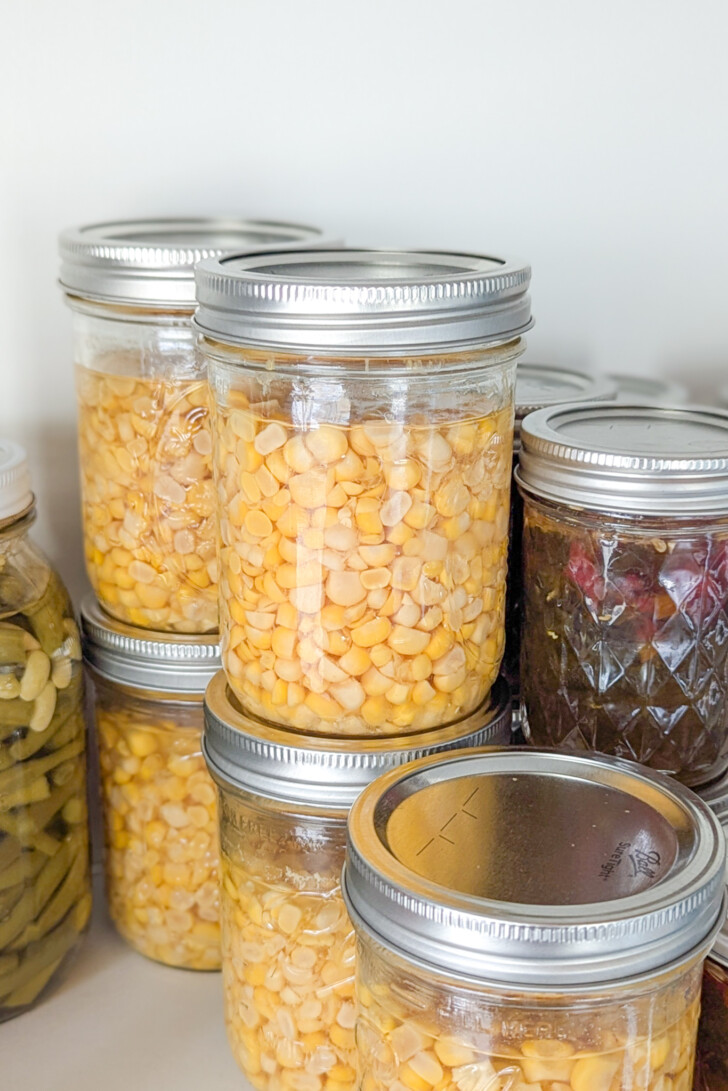jars of canned corn on a shelf