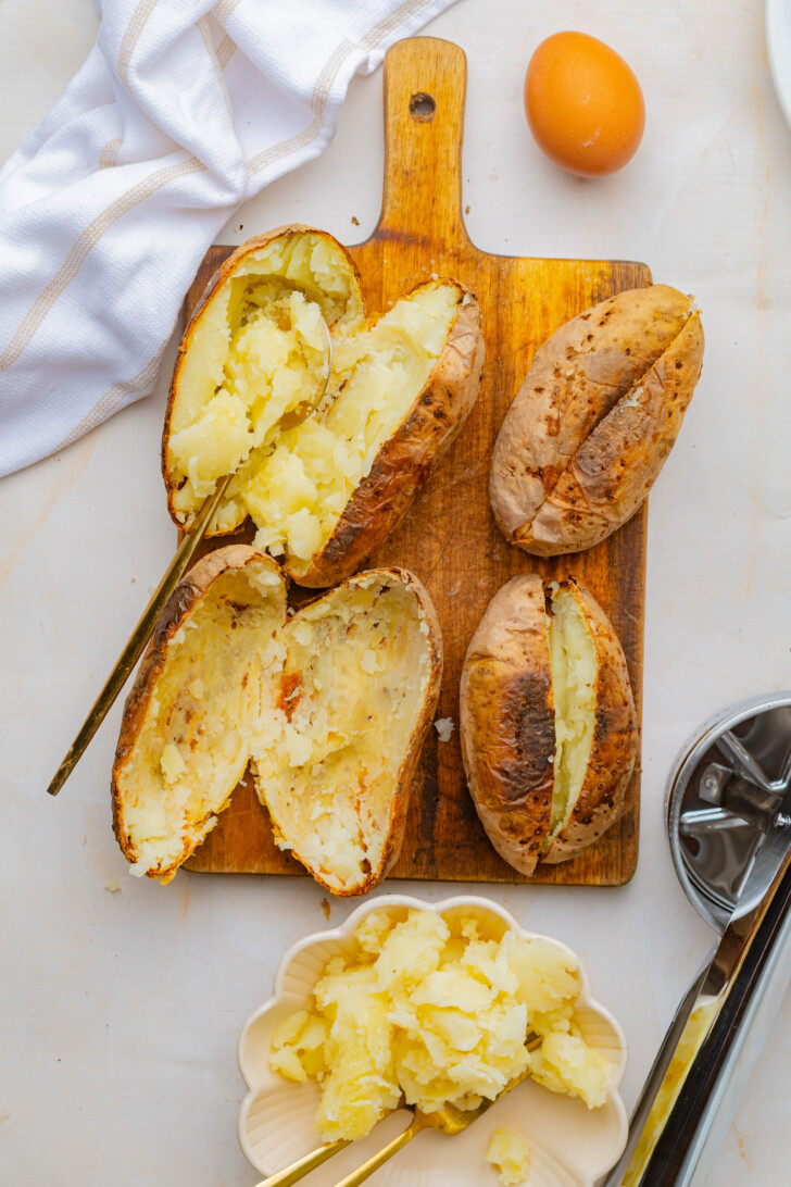 cooked russet potatoes being scooped out