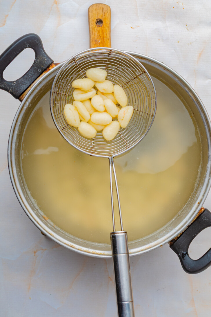 gnocchi being boiled in a pot of salted water